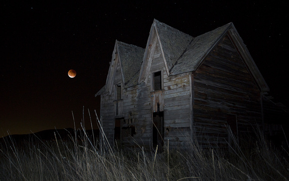 Old farmhouse and lunar eclipse, eastern Washington