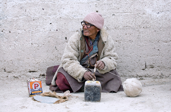 5 Man "spindling" wool for looming, Rumbak village, Ladakh, India