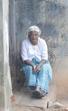 Woman on porch, Fort Kochi, Kerala, India