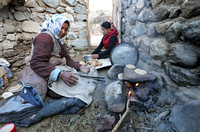 Baking khambir (Ladakhi bread) over dung fire, Ladakh, India