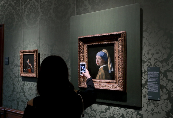 Woman photographing Vermeer's "Girl with a Pearl Earring", Mauritshuis, The Hague, The Netherlands
