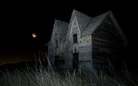Abandoned farmhouse with "supermoon" lunar eclipse, eastern Washington