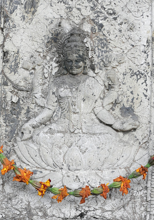 Hindu stone carving and flowers, Delhi, India