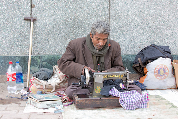 Man sewing on street, Delhi, India