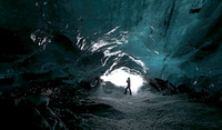 Crystal ice cave with climber, Vatnajokull, Iceland