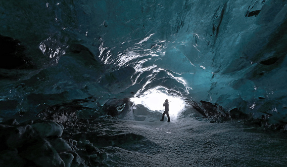 Climber at ice cave entrance, Iceland