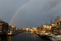 Rainbow over canal, Amsterdam, The Netherlands