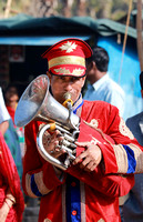 Man playing horn at Holi festivities, Vrindavan, India