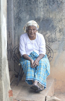 Woman sitting on porch, Cochin, Kerala, India